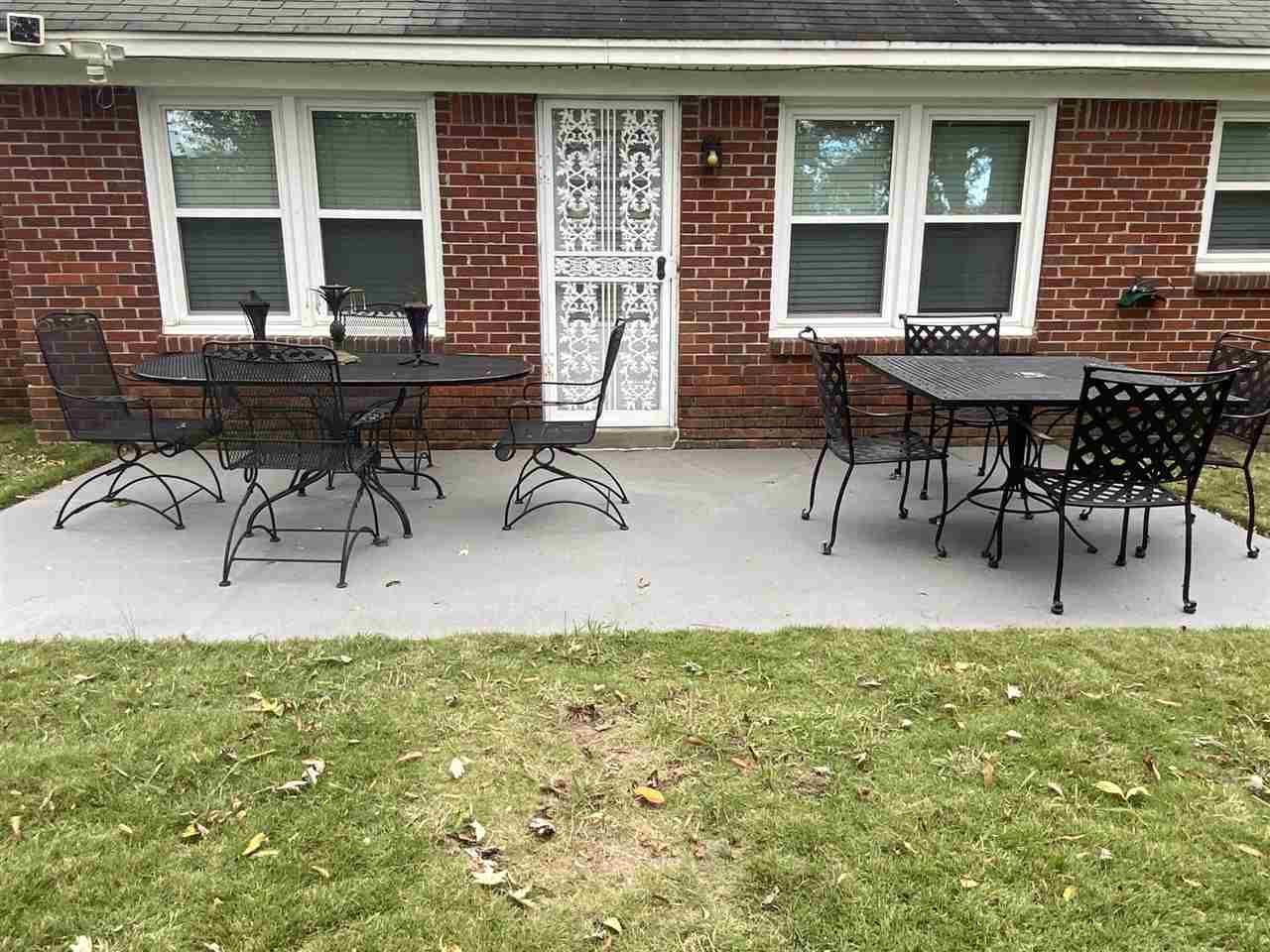 322 McElroy Road Memphis, TN 38120 - Photo 3 of 16 a view of a house with patio and a yard