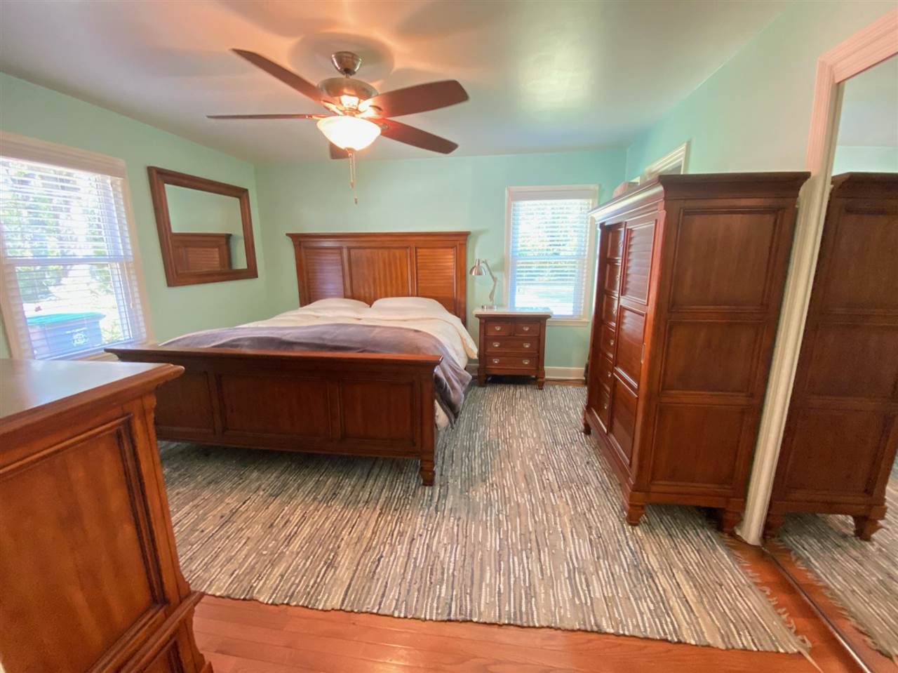 322 McElroy Road Memphis, TN 38120 - Photo 9 of 16 a bedroom with a bed a dresser and wooden floor
