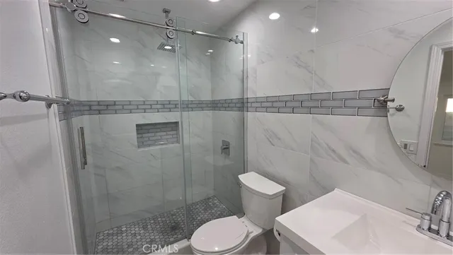 a bathroom with a toilet a sink and shower