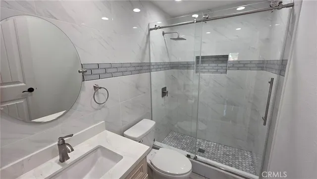 a bathroom with a toilet a sink and shower