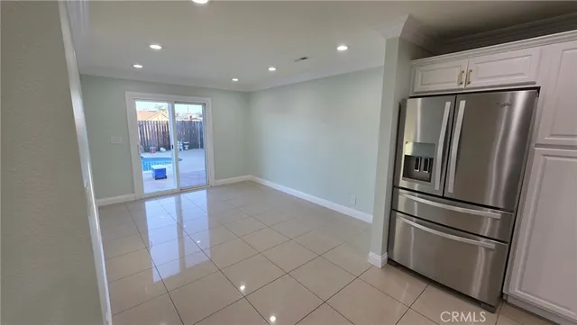 a kitchen with stainless steel appliances a refrigerator and microwave