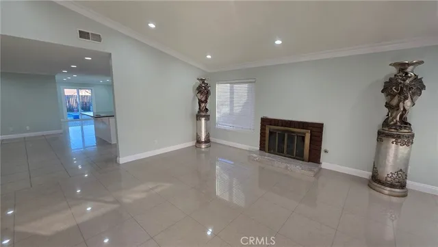 wooden floor in a room with a fireplace and window