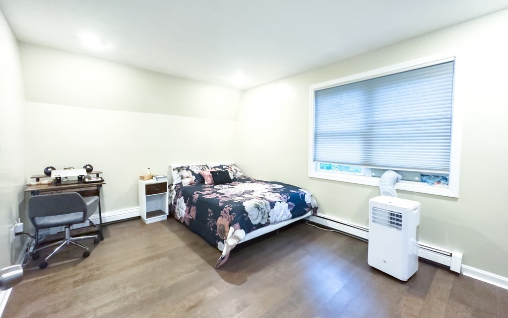 308 Acropolis Road Lowell, MA 01854 - Photo 14 of 21 a bedroom with a bed and a window