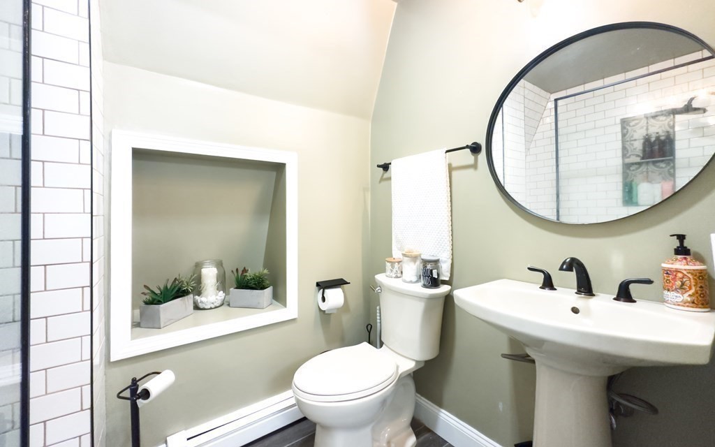 308 Acropolis Road Lowell, MA 01854 - Photo 16 of 21 a bathroom with a toilet a sink and mirror
