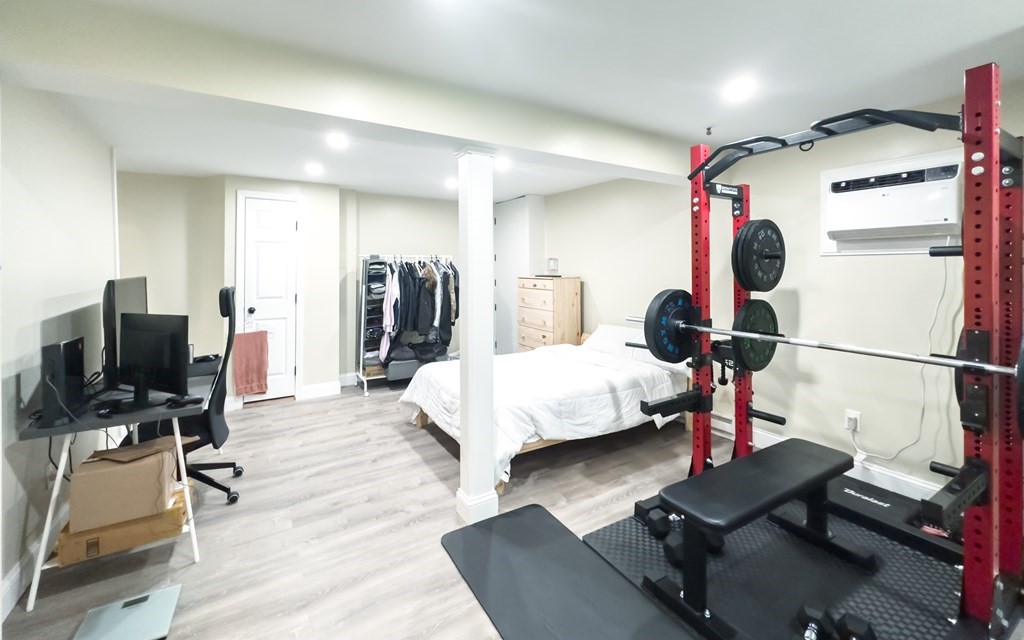 308 Acropolis Road Lowell, MA 01854 - Photo 18 of 21 a bedroom with a bed and a flat screen tv