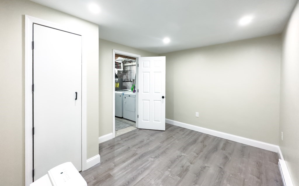 308 Acropolis Road Lowell, MA 01854 - Photo 20 of 21 a view of empty room with wooden floor