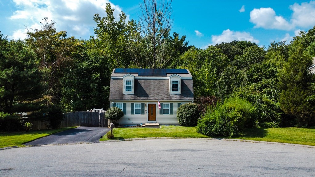 308 Acropolis Road Lowell, MA 01854 - Photo 2 of 21 a front view of a house with a yard and garage
