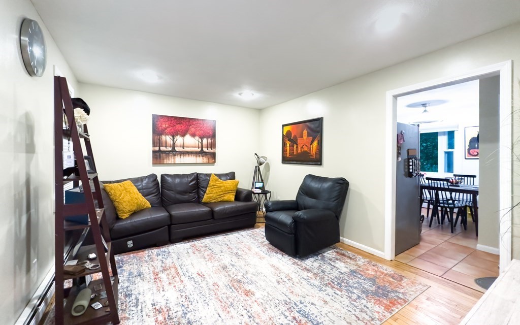 308 Acropolis Road Lowell, MA 01854 - Photo 7 of 21 a living room with furniture a rug and a flat screen tv