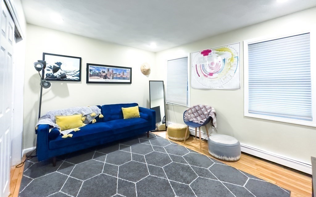 308 Acropolis Road Lowell, MA 01854 - Photo 10 of 21 a living room with furniture and wall paintings
