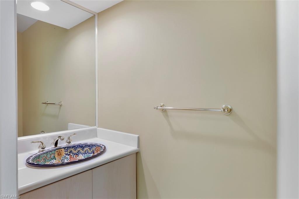 3578 Midas Place Naples, FL 34105 - Photo 13 of 21 a bathroom with a granite countertop sink and a white shower