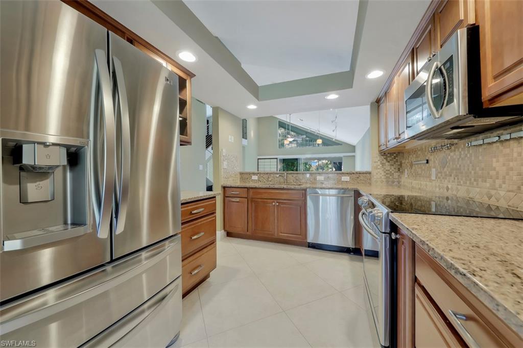 3578 Midas Place Naples, FL 34105 - Photo 6 of 21 a kitchen with stainless steel appliances granite countertop a refrigerator a stove and a sink