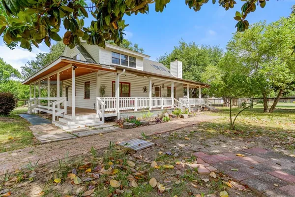 a view of a house with backyard sitting area and garden