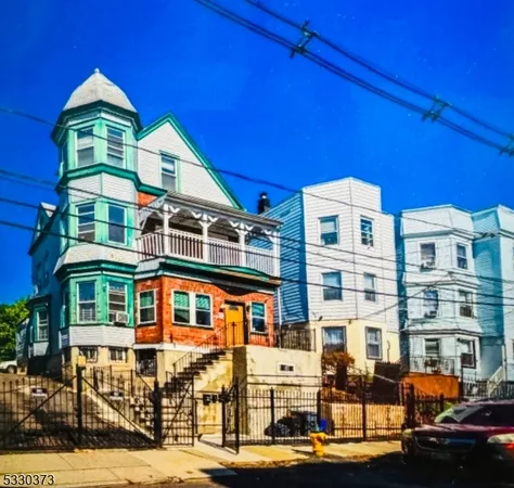 a front view of a residential apartment building with a yard