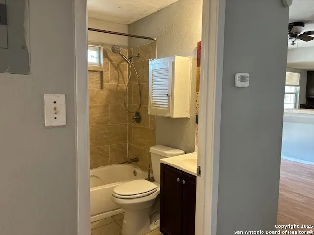 a bathroom with a shower a toilet and a sink