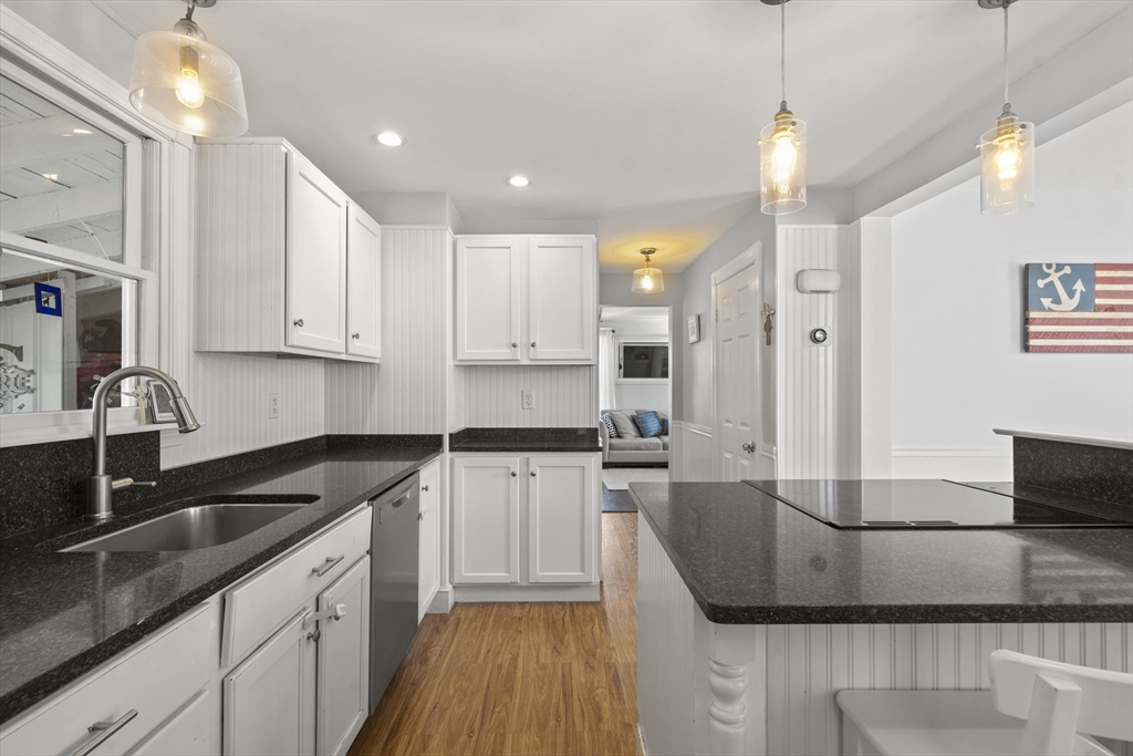 446 Ralph Talbot Street Weymouth, MA 02190 - Photo 11 of 28 a kitchen with stainless steel appliances granite countertop a sink a stove and cabinets