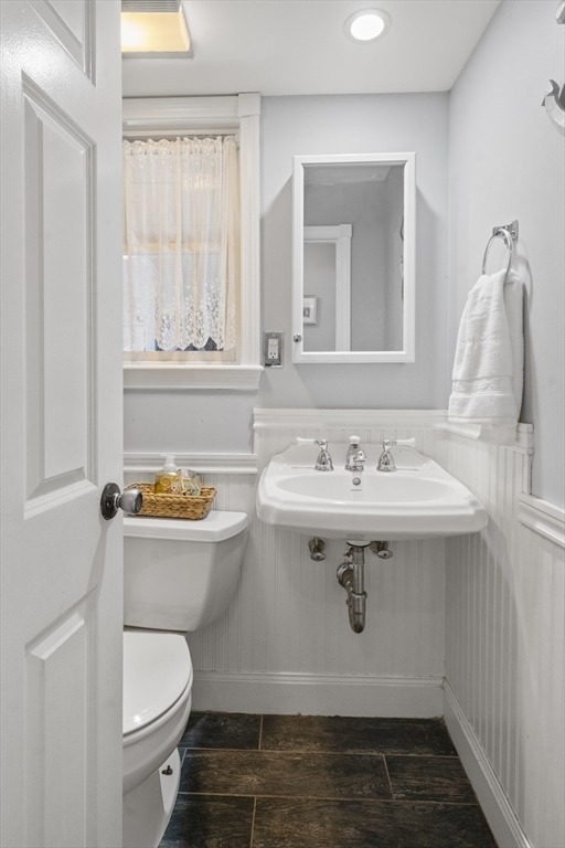 446 Ralph Talbot Street Weymouth, MA 02190 - Photo 12 of 28 a bathroom with a sink toilet and mirror