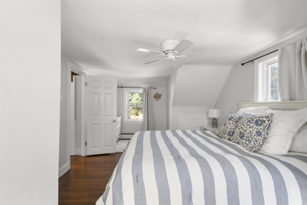 446 Ralph Talbot Street Weymouth, MA 02190 - Photo 14 of 28 a bedroom with a large bed and a chandelier