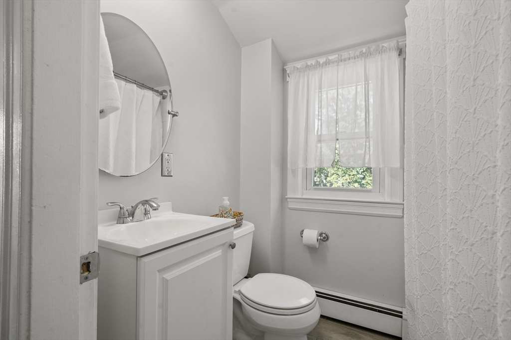 446 Ralph Talbot Street Weymouth, MA 02190 - Photo 16 of 28 a bathroom with a sink a toilet and vanity