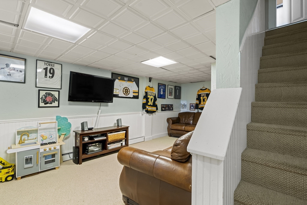 446 Ralph Talbot Street Weymouth, MA 02190 - Photo 22 of 28 a living room with furniture and a flat screen tv