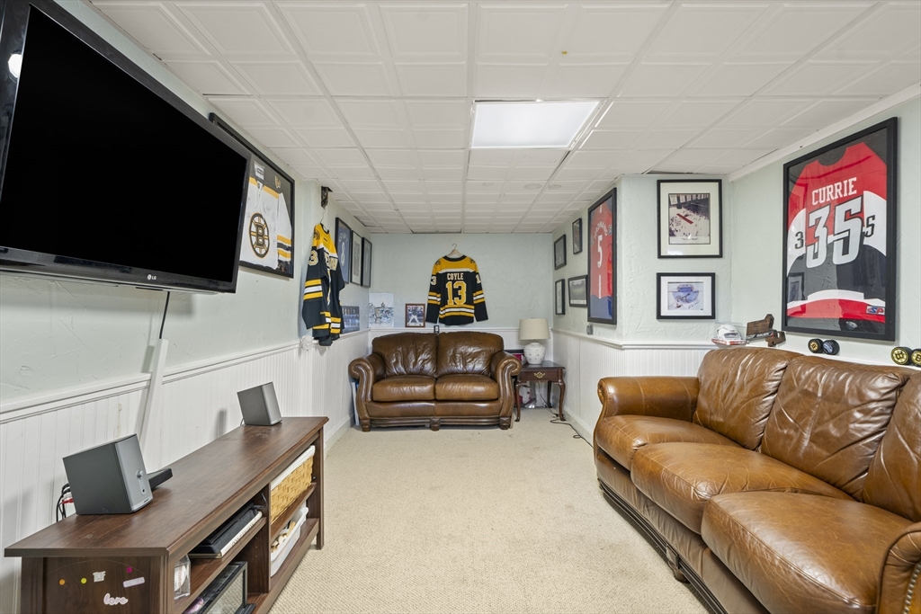 446 Ralph Talbot Street Weymouth, MA 02190 - Photo 23 of 28 a living room with furniture and a flat screen tv