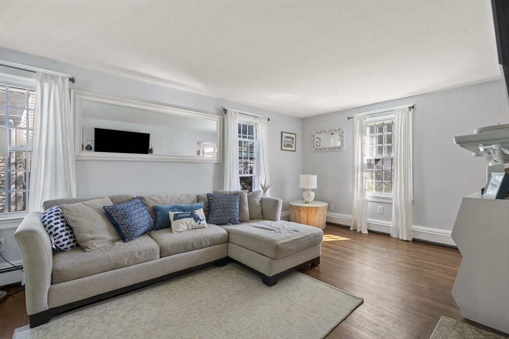 446 Ralph Talbot Street Weymouth, MA 02190 - Photo 3 of 28 a living room with furniture and a flat screen tv