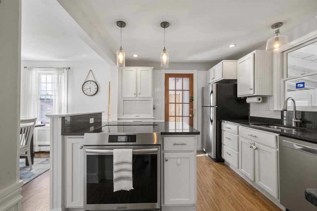446 Ralph Talbot Street Weymouth, MA 02190 - Photo 9 of 28 a kitchen with stainless steel appliances granite countertop a stove a sink and a refrigerator