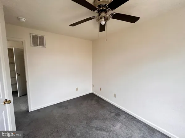 an empty room with a fan