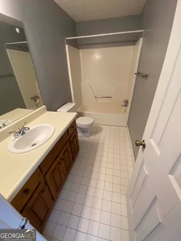 a bathroom with a sink a toilet and a shower