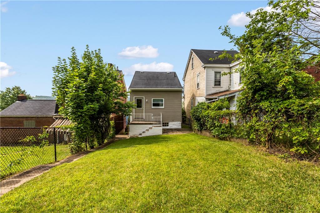 435 Walde Street Pittsburgh, PA 15210 - Photo 5 of 10 a view of a house with a yard and sitting area