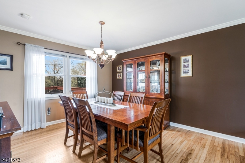 496 Rolling Hills Road Bridgewater, NJ 08807 - Photo 14 of 45 a dining room with furniture a chandelier and wooden floor