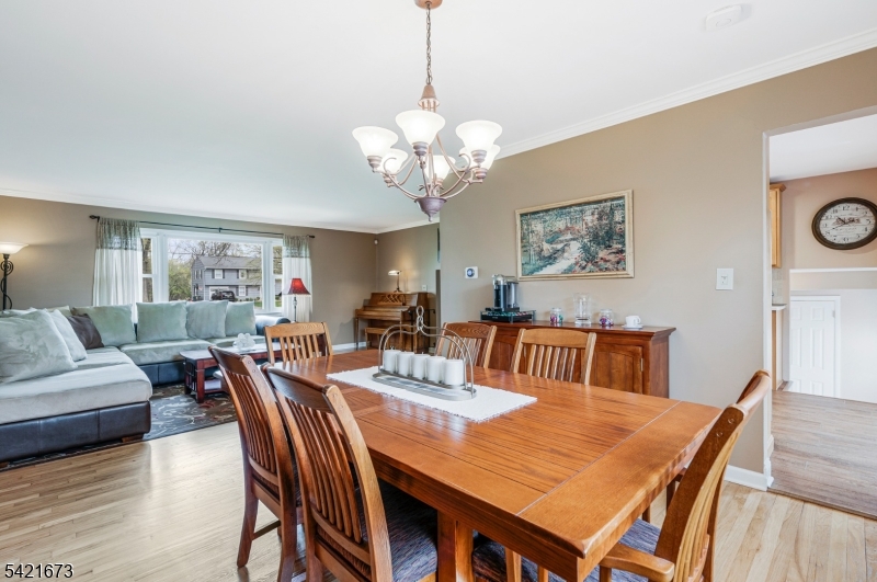 496 Rolling Hills Road Bridgewater, NJ 08807 - Photo 15 of 45 a view of a dining room with furniture and chandelier