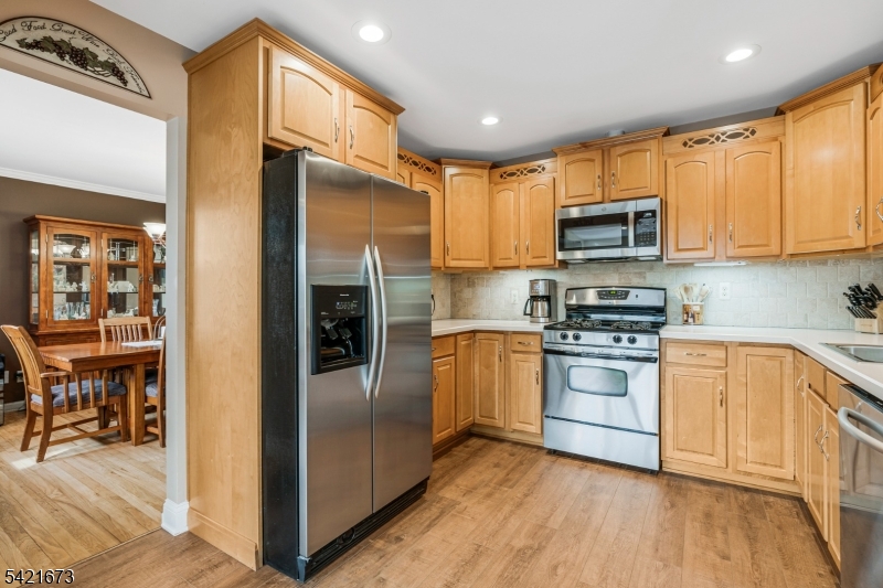 496 Rolling Hills Road Bridgewater, NJ 08807 - Photo 16 of 45 a kitchen with stainless steel appliances a refrigerator stove microwave and sink