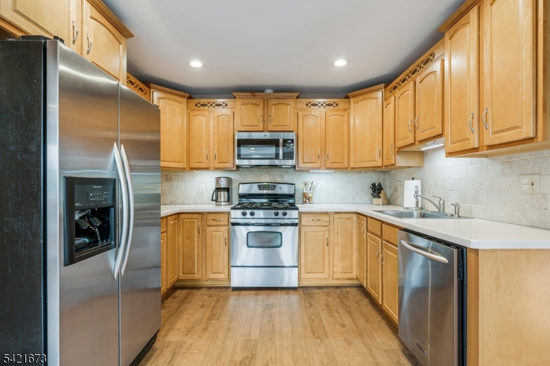 496 Rolling Hills Road Bridgewater, NJ 08807 - Photo 17 of 45 a kitchen with stainless steel appliances granite countertop a stove a sink and a refrigerator