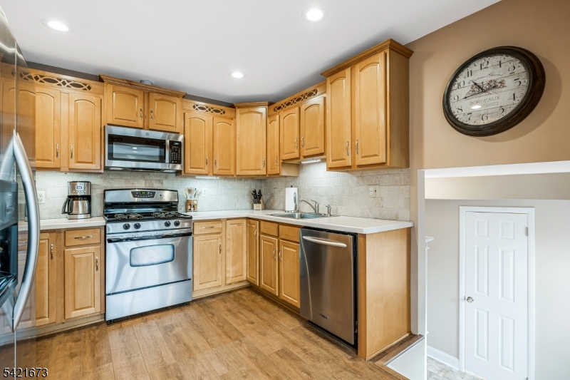 496 Rolling Hills Road Bridgewater, NJ 08807 - Photo 18 of 45 a kitchen with stainless steel appliances granite countertop a stove a sink and a microwave
