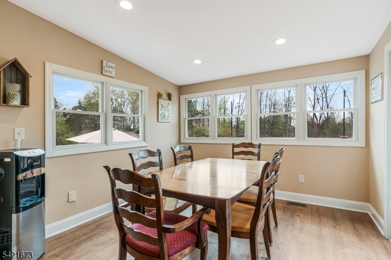 496 Rolling Hills Road Bridgewater, NJ 08807 - Photo 20 of 45 a view of a dining room with furniture large windows and wooden floor