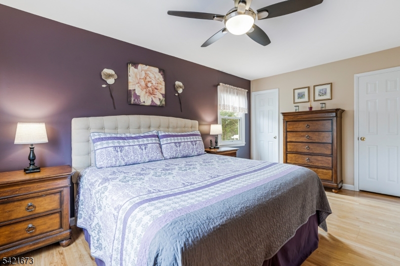 496 Rolling Hills Road Bridgewater, NJ 08807 - Photo 24 of 45 a bedroom with a bed and a chandelier