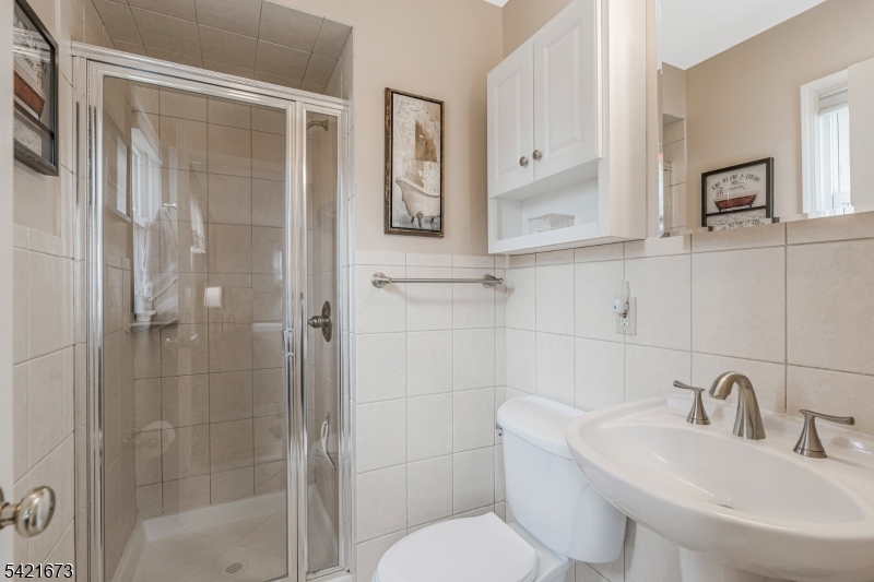 496 Rolling Hills Road Bridgewater, NJ 08807 - Photo 25 of 45 a bathroom with a toilet sink and shower