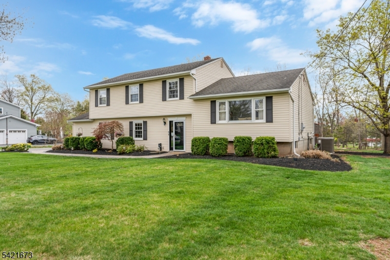 496 Rolling Hills Road Bridgewater, NJ 08807 - Photo 3 of 45 a front view of a house with a yard and trees