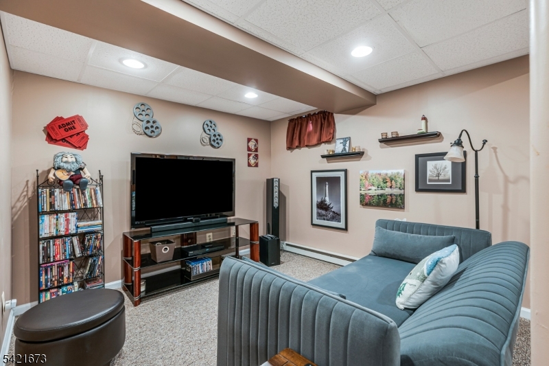 496 Rolling Hills Road Bridgewater, NJ 08807 - Photo 31 of 45 a living room with furniture and a flat screen tv