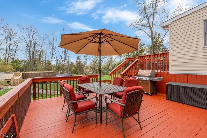 496 Rolling Hills Road Bridgewater, NJ 08807 - Photo 35 of 45 a view of deck with furniture and umbrella