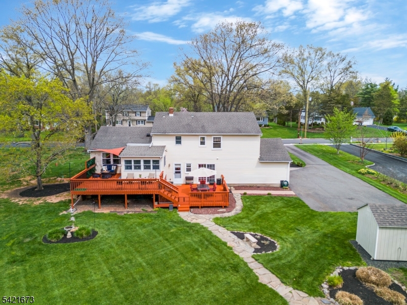 496 Rolling Hills Road Bridgewater, NJ 08807 - Photo 38 of 45 a front view of a house with a yard table and chairs