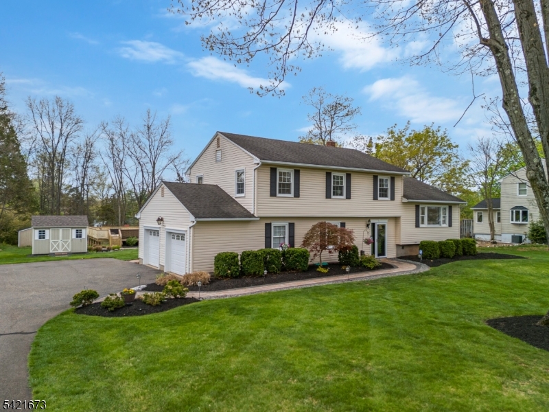 496 Rolling Hills Road Bridgewater, NJ 08807 - Photo 4 of 45 a front view of a house with a garden and trees