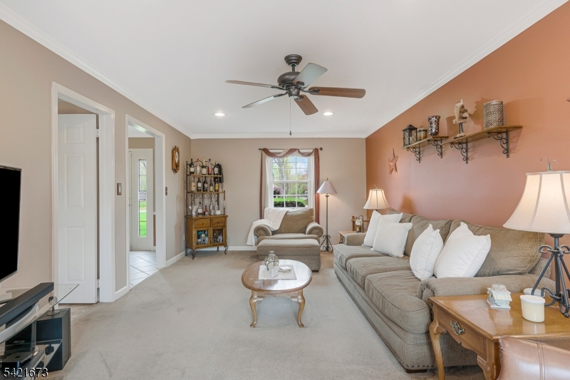 496 Rolling Hills Road Bridgewater, NJ 08807 - Photo 5 of 45 a living room with furniture and a flat screen tv