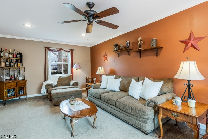 496 Rolling Hills Road Bridgewater, NJ 08807 - Photo 6 of 45 a living room with furniture and a flat screen tv