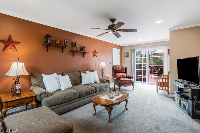 496 Rolling Hills Road Bridgewater, NJ 08807 - Photo 7 of 45 a living room with furniture and a flat screen tv