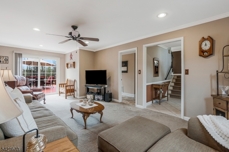 496 Rolling Hills Road Bridgewater, NJ 08807 - Photo 8 of 45 a living room with furniture a flat screen tv and kitchen view