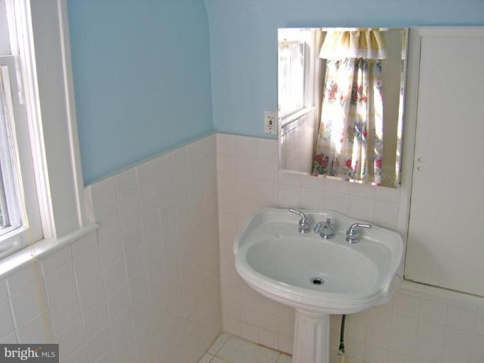 8605 Mayfair Place Silver Spring, MD 20910 - Photo 2 of 23 a bathroom with a sink and mirror