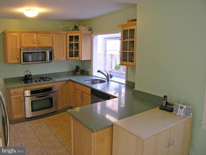 8605 Mayfair Place Silver Spring, MD 20910 - Photo 12 of 23 a kitchen that has a sink and a stove in it