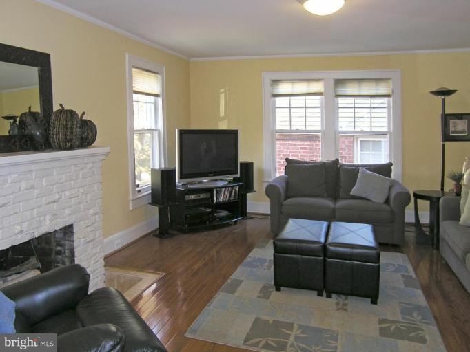 8605 Mayfair Place Silver Spring, MD 20910 - Photo 15 of 23 a living room with furniture a flat screen tv and a fireplace