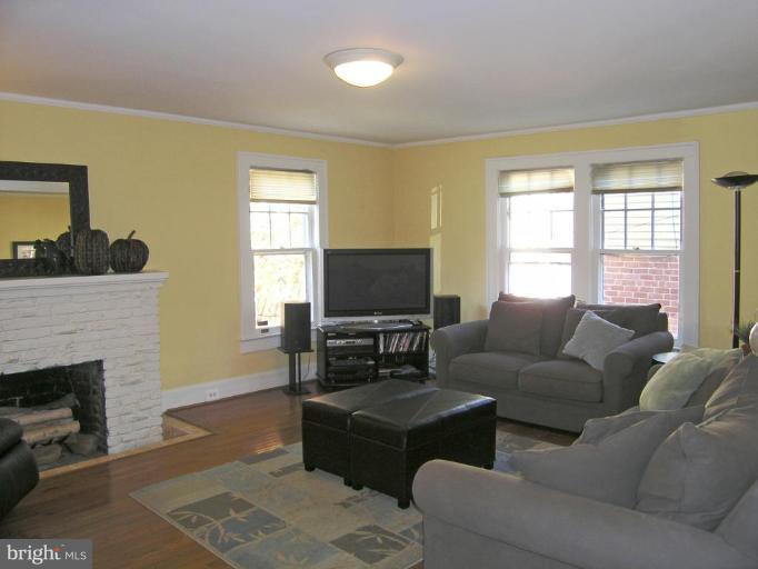 8605 Mayfair Place Silver Spring, MD 20910 - Photo 16 of 23 a living room with furniture a flat screen tv and a fireplace